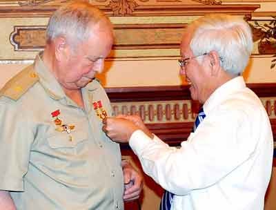 City mayor Le Hoang Quan(R) pins a medal to the shirt of Russian cosmonaut Victor Gorbatko (Photo: SGGP)