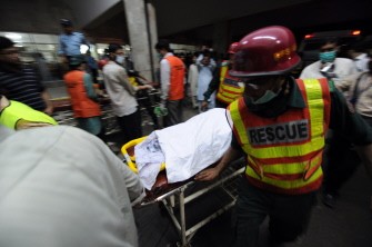 Pakistani rescue workers push the body of a plane crash victim on a stretcher into hospital as relatives gather to collect their remains in Islamabad on July 28, 2010. AFP Pakistani rescue workers push the body of a plane crash victim on a stretcher into hospital as relatives gather to collect their remains in Islamabad on July 28, 2010. AFP