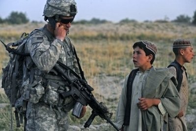 Afghan children look on as US soldiers take part in a patrol in the village of Rambasi, Dand District on the outskirts of Kandahar earlier this year. Afghan children look on as US soldiers take part in a patrol in the village of Rambasi, Dand District on the outskirts of Kandahar earlier this year.