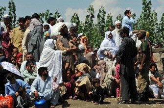 Pakistani flood survivors speak with sucurity personnel as they wait for their turn to board army boats while they are evacuated from the flood-hit Chakdarra area of Swat on August 4, 2010. AFP Pakistani flood survivors speak with sucurity personnel as they wait for their turn to board army boats while they are evacuated from the flood-hit Chakdarra area of Swat on August 4, 2010. AFP