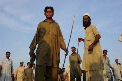 Pakistani flood survivors block a motorway to demand relief supplies in Charsadda on August 4, 2010. Pakistani flood survivors block a motorway to demand relief supplies in Charsadda on August 4, 2010.