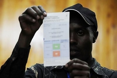 A Kenyan poll worker helps count votes at a local polling station in the western Kenyan town of Eldoret. A Kenyan poll worker helps count votes at a local polling station in the western Kenyan town of Eldoret.