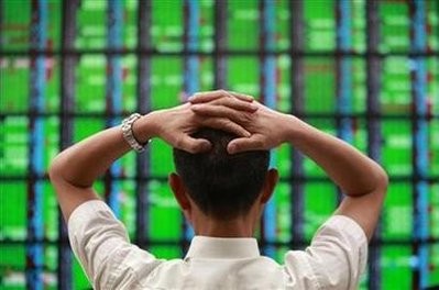 A man looks at a display board showing stock market prices inside a brokerage in Taipei May 25, 2010. A man looks at a display board showing stock market prices inside a brokerage in Taipei May 25, 2010.