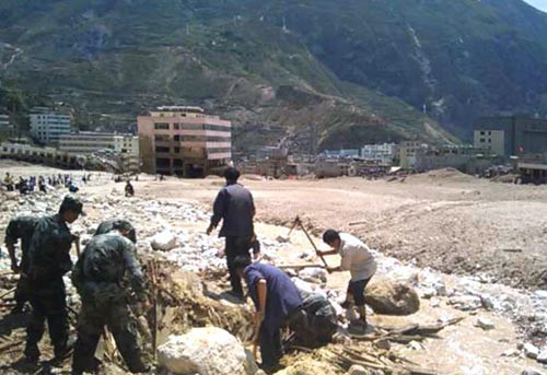 Rescuers clear up stones and mud on a road after a landslide destroyed a village of more than 300 families in Zhouqu County, Gannan Tibetan Autonomous Prefecture in Gansu Province, August 8, 2010. (Photo: Xinhua) Rescuers clear up stones and mud on a road after a landslide destroyed a village of more than 300 families in Zhouqu County, Gannan Tibetan Autonomous Prefecture in Gansu Province, August 8, 2010. (Photo: Xinhua)