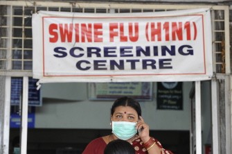 An Indian woman, wearing a mask, talks on her mobile phone outside the H1N1 swine flu screening centre at the Government Gandhi Hospital in Hyderabad on August 7, 2010. AFP An Indian woman, wearing a mask, talks on her mobile phone outside the H1N1 swine flu screening centre at the Government Gandhi Hospital in Hyderabad on August 7, 2010. AFP