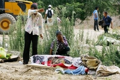Survivors grieve for a relative killed during the deadly flood-triggered landslides in Zhouqu, in northwest China's Gansu province. Survivors grieve for a relative killed during the deadly flood-triggered landslides in Zhouqu, in northwest China's Gansu province.