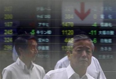 People are reflected on an electronic board displaying share prices outside a brokerage in Tokyo July 6, 2010 People are reflected on an electronic board displaying share prices outside a brokerage in Tokyo July 6, 2010
