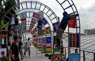 This photo taken on August 10, 2010 shows workers hanging up flags of participating countries in preparation for the inaugural Youth Olympic Games in Singapore. AFP This photo taken on August 10, 2010 shows workers hanging up flags of participating countries in preparation for the inaugural Youth Olympic Games in Singapore. AFP