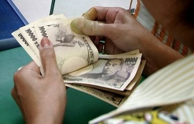 A clerk counts bank notes at a lottery booth in Tokyo. A clerk counts bank notes at a lottery booth in Tokyo.