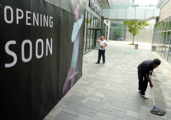 A Chinese cleaner wipes the floor of a shopping mall with new outlets soon to open in Beijing on August 17, 2010. China on August 17 hailed the country's economic might after it overtook world number two Japan in the second quarter but said it still had tens of millions of people living in poverty. A Chinese cleaner wipes the floor of a shopping mall with new outlets soon to open in Beijing on August 17, 2010. China on August 17 hailed the country's economic might after it overtook world number two Japan in the second quarter but said it still had tens of millions of people living in poverty.