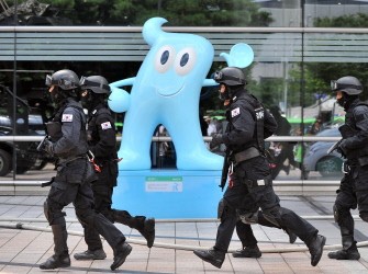 South Korean police SWAT team members run past an exhibit mascot during an anti-terror drill as part of a joint US-South Korean military exercise in Seoul on August 18, 2010. AFP South Korean police SWAT team members run past an exhibit mascot during an anti-terror drill as part of a joint US-South Korean military exercise in Seoul on August 18, 2010. AFP