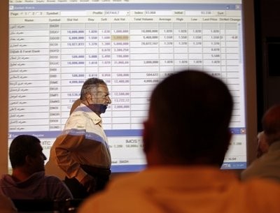 In this photo taken on Sunday, July 25, 2010, Iraqi stock traders watch the sales screen at the Iraq Stock Exchange in Baghdad, Iraq In this photo taken on Sunday, July 25, 2010, Iraqi stock traders watch the sales screen at the Iraq Stock Exchange in Baghdad, Iraq