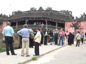 This file photo shows foreign tourists at the Japanese Bridge in Hoi An Ancient Town. The bridge is a unique covered structure built by the Japanese, the only known covered bridge with a Buddhist pagoda attached to one side. (Photo: Binh Phuong) This file photo shows foreign tourists at the Japanese Bridge in Hoi An Ancient Town. The bridge is a unique covered structure built by the Japanese, the only known covered bridge with a Buddhist pagoda attached to one side. (Photo: Binh Phuong)