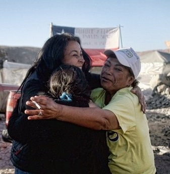 Relatives of the miners trapped in the San Esteban gold and copper mine, hug each other at the news that the 33 Chilean miners trapped deep below ground for 17 days are alive. Relatives of the miners trapped in the San Esteban gold and copper mine, hug each other at the news that the 33 Chilean miners trapped deep below ground for 17 days are alive.