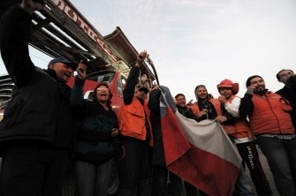 Relatives of the trapped miners pose with rescuers as they leave their work shift on August 24, 2010. AFP Relatives of the trapped miners pose with rescuers as they leave their work shift on August 24, 2010. AFP