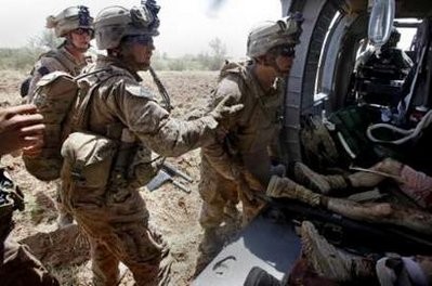 U.S. Marines talk to medevac helicopter crew members after loading two comrades gravely wounded in an IED (improvised explosive device) blast near the town of Marjah in Helmand Province in this picture taken August 22, 2010. U.S. Marines talk to medevac helicopter crew members after loading two comrades gravely wounded in an IED (improvised explosive device) blast near the town of Marjah in Helmand Province in this picture taken August 22, 2010.