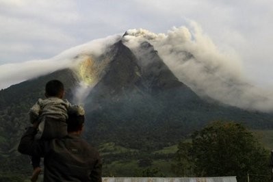 A man and his son watch as the Sinabung volcano spews thick smoke in Karo district in North Sumatra on August 29. A man and his son watch as the Sinabung volcano spews thick smoke in Karo district in North Sumatra on August 29.