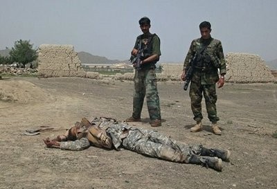 Afghan National Army (ANA) soldiers stand guard next to the body of a suicide attacker near US military camp Salerno on the outskirts of Khost city Afghan National Army (ANA) soldiers stand guard next to the body of a suicide attacker near US military camp Salerno on the outskirts of Khost city
