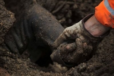 A rescuer holds the arm of the body of a person buried by a landslide in the Nahuala municipality, Solola, west of Guatemala City, on September 5, 2010. AFP A rescuer holds the arm of the body of a person buried by a landslide in the Nahuala municipality, Solola, west of Guatemala City, on September 5, 2010. AFP