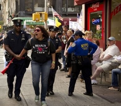 A protester in support of an Islamic center two blocks from Ground Zero is led away from a rally against the mosque by police on September 11, 2010 in New York A protester in support of an Islamic center two blocks from Ground Zero is led away from a rally against the mosque by police on September 11, 2010 in New York