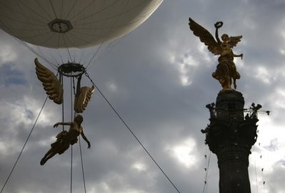 An person dressed in the likeness of the Angel of Independence, left, floats by the Angel of Independence monument during a bicentennial parade in Mexico City, Wednesday Sept. 15, 2010 An person dressed in the likeness of the Angel of Independence, left, floats by the Angel of Independence monument during a bicentennial parade in Mexico City, Wednesday Sept. 15, 2010