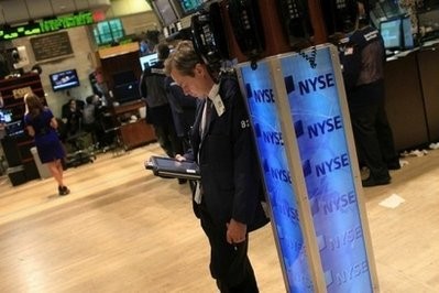 A trader studies figures at the New York Stock Exchange. A trader studies figures at the New York Stock Exchange.