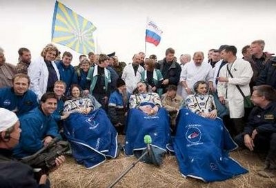 U.S. astronaut Tracy Caldwell Dyson (L), Russian cosmonauts Alexander Skvortsov (C) and Mikhail Kornienko sit outside the Soyuz Capsule just minutes after they landed near the town of Arkalyk, northern Kazakhstan September 25, 2010. U.S. astronaut Tracy Caldwell Dyson (L), Russian cosmonauts Alexander Skvortsov (C) and Mikhail Kornienko sit outside the Soyuz Capsule just minutes after they landed near the town of Arkalyk, northern Kazakhstan September 25, 2010.