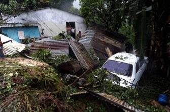 Neighbours of the colonia Grimaldi in the town of San Marcos, San Salvador, El Salvador, stare at the damages in their house after a mudslide caused by heavy rains in the country on September 29, 2010. Salvadorean goverment declared both an orange and red alert --depending on the region-- due to tropical storm Nicole. AFP Neighbours of the colonia Grimaldi in the town of San Marcos, San Salvador, El Salvador, stare at the damages in their house after a mudslide caused by heavy rains in the country on September 29, 2010. Salvadorean goverment declared both an orange and red alert --depending on the region-- due to tropical storm Nicole. AFP