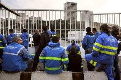 Dockers from Marseille block the way to the harbour during a strike on October . Dockers from Marseille block the way to the harbour during a strike on October .