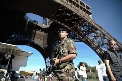 A French soldier patrols the Eiffel Tower in Paris. A French soldier patrols the Eiffel Tower in Paris.