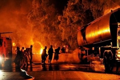Pakistani firefighters try to extinguish burning NATO oil tankers following a Taliban attack in Nowshera on October 7, 2010. Pakistani firefighters try to extinguish burning NATO oil tankers following a Taliban attack in Nowshera on October 7, 2010.