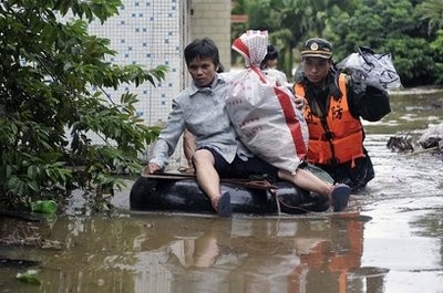 In this Oct. 6, 2010 photo released by China's Xinhua News Agency, rescuers transfer residents to safe areas in Qionghai, south China's Hainan Province. In this Oct. 6, 2010 photo released by China's Xinhua News Agency, rescuers transfer residents to safe areas in Qionghai, south China's Hainan Province.