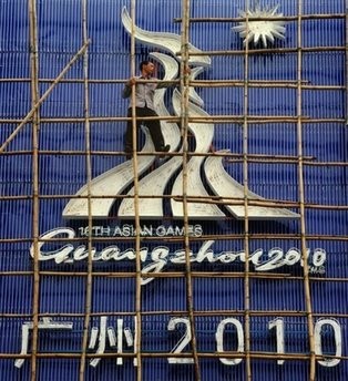 (AFP) A Chinese worker affixes a sign to a stadium on September 28, for the upcoming 2010 Asian Games in Guangzhou. (AFP) A Chinese worker affixes a sign to a stadium on September 28, for the upcoming 2010 Asian Games in Guangzhou.