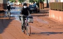 A woman rides her bicycle down a street covered in the toxic sludge from the burst at an alumina plant. AFP A woman rides her bicycle down a street covered in the toxic sludge from the burst at an alumina plant. AFP