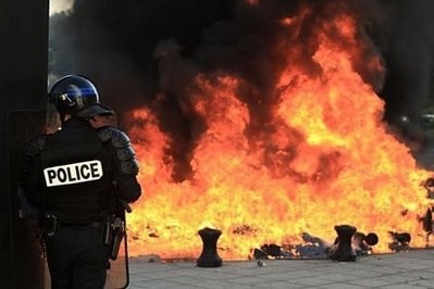 A French riot policemen stands in front of the Employers' union Medef regional headquarters in Caen following clashes at the end of a demonstration against plans to up the retirement age to 62. A French riot policemen stands in front of the Employers' union Medef regional headquarters in Caen following clashes at the end of a demonstration against plans to up the retirement age to 62.