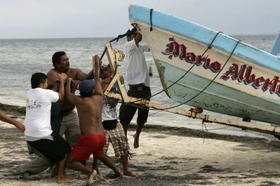 Fishermen try to secure a boat as before the estimated arrival of hurricane Paula to Mexico's Yucatan peninsula, Tuesday, Oct. 12, 2010 Fishermen try to secure a boat as before the estimated arrival of hurricane Paula to Mexico's Yucatan peninsula, Tuesday, Oct. 12, 2010