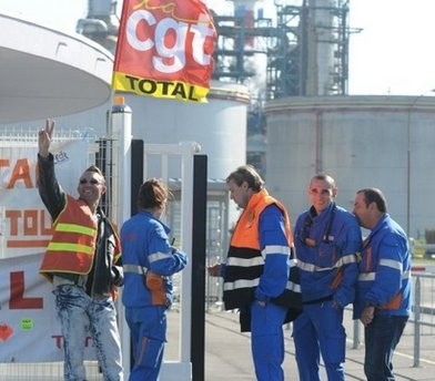 (AFP) An employee of French oil giant Total makes a victory sign after a meeting to decide on further strike action at the group's refinerie in Donges (AFP) An employee of French oil giant Total makes a victory sign after a meeting to decide on further strike action at the group's refinerie in Donges