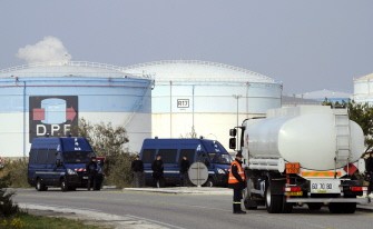 A tanker truck drives pas French gendarmes securing the oil terminal in Fos-sur-Mer on October 15, 2010 after police moved in to reopen three fuel storage depots blocked by striking workers. AFP A tanker truck drives pas French gendarmes securing the oil terminal in Fos-sur-Mer on October 15, 2010 after police moved in to reopen three fuel storage depots blocked by striking workers. AFP