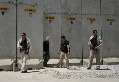 AFP file - Private security officers protect Afghan President Hamid Karzai (2nd L) during a visit to in Bagram Airfield in May 2010. AFP file - Private security officers protect Afghan President Hamid Karzai (2nd L) during a visit to in Bagram Airfield in May 2010.