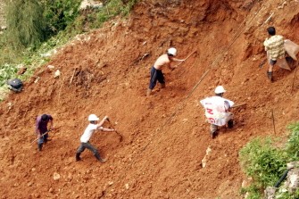 Volunteers help clear mudslide near a house in Baguio City, Benguet province, north of Manila on October 20, 2010. AFP Volunteers help clear mudslide near a house in Baguio City, Benguet province, north of Manila on October 20, 2010. AFP