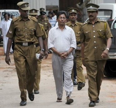 Sri Lankan prison officials escort Tamil journalist J. S. Tissainayagam (C) to a prison bus in August, 2009. Sri Lankan prison officials escort Tamil journalist J. S. Tissainayagam (C) to a prison bus in August, 2009.