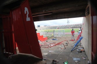 A Kenyan police investigator talks near the spot where seven people were killed and scores others injured at the Nyayo National stadium in Nairobi on Ocotber 24, 2010. A Kenyan police investigator talks near the spot where seven people were killed and scores others injured at the Nyayo National stadium in Nairobi on Ocotber 24, 2010.