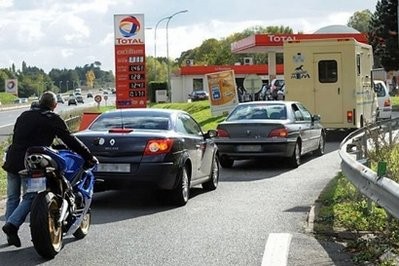 A motorcyclist queues up with drivers at a gas station in Nantes, western France A motorcyclist queues up with drivers at a gas station in Nantes, western France