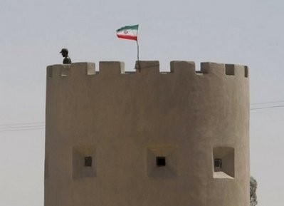 An Iranian policeman stands guard along the road which separates Iran from Afghanistan. AFP An Iranian policeman stands guard along the road which separates Iran from Afghanistan. AFP