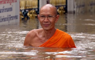 A Buddhist monk wades through floodwaters at a Buddhist temple in Ayutthaya province on October 25, 2010. AFP A Buddhist monk wades through floodwaters at a Buddhist temple in Ayutthaya province on October 25, 2010. AFP