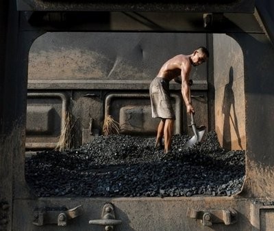 A Chinese miner unloads coal from a train in eastern China's Anhui province. A Chinese miner unloads coal from a train in eastern China's Anhui province.
