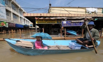 A Thai villager paddles through floodwater in Ayutthaya province, north of the Thai capital Bangkok on October 30, 2010. AFP A Thai villager paddles through floodwater in Ayutthaya province, north of the Thai capital Bangkok on October 30, 2010. AFP