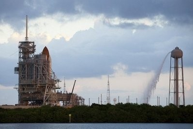 Space Shuttle Discovery sits behind the protective rotating service structure on launch pad 39-a in Cape Canaveral, Florida. Space Shuttle Discovery sits behind the protective rotating service structure on launch pad 39-a in Cape Canaveral, Florida.