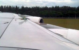 This image taken by passenger Ulf Waschbusch shows the damage wing and engine of the troubled Qantas Airbus A380 plane after an emergency landing at the Changi International airport in Singapore on November 4. AFP This image taken by passenger Ulf Waschbusch shows the damage wing and engine of the troubled Qantas Airbus A380 plane after an emergency landing at the Changi International airport in Singapore on November 4. AFP
