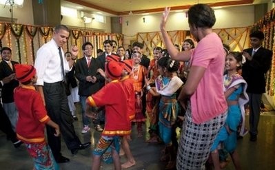 US President Barack Obama and First Lady Michelle Obama dance during a cultural event at The Holy Name High School in Mumbai. US President Barack Obama and First Lady Michelle Obama dance during a cultural event at The Holy Name High School in Mumbai.